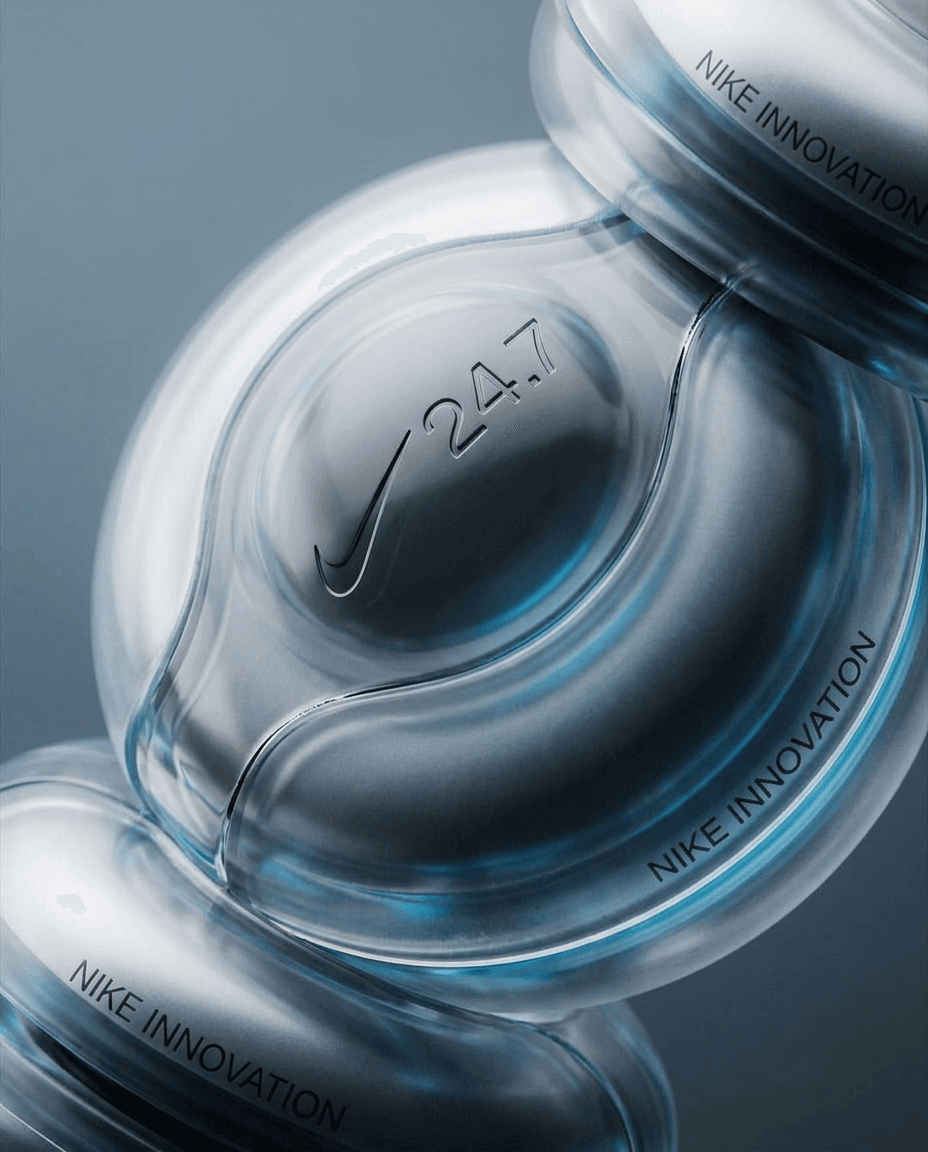Close-up of a transparent object with smooth curves and blue lighting.