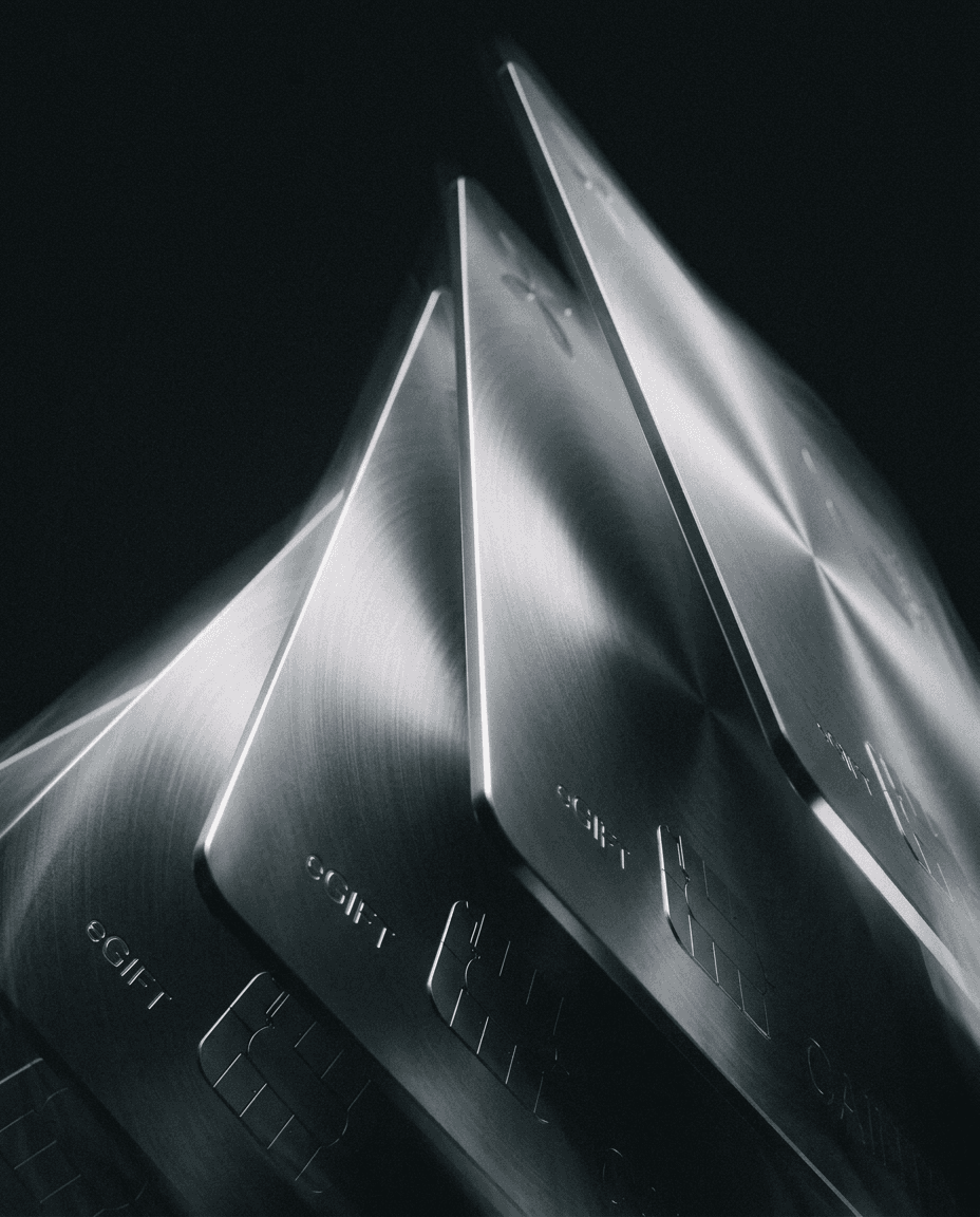 Close-up of shiny metallic credit cards stacked at an angle.