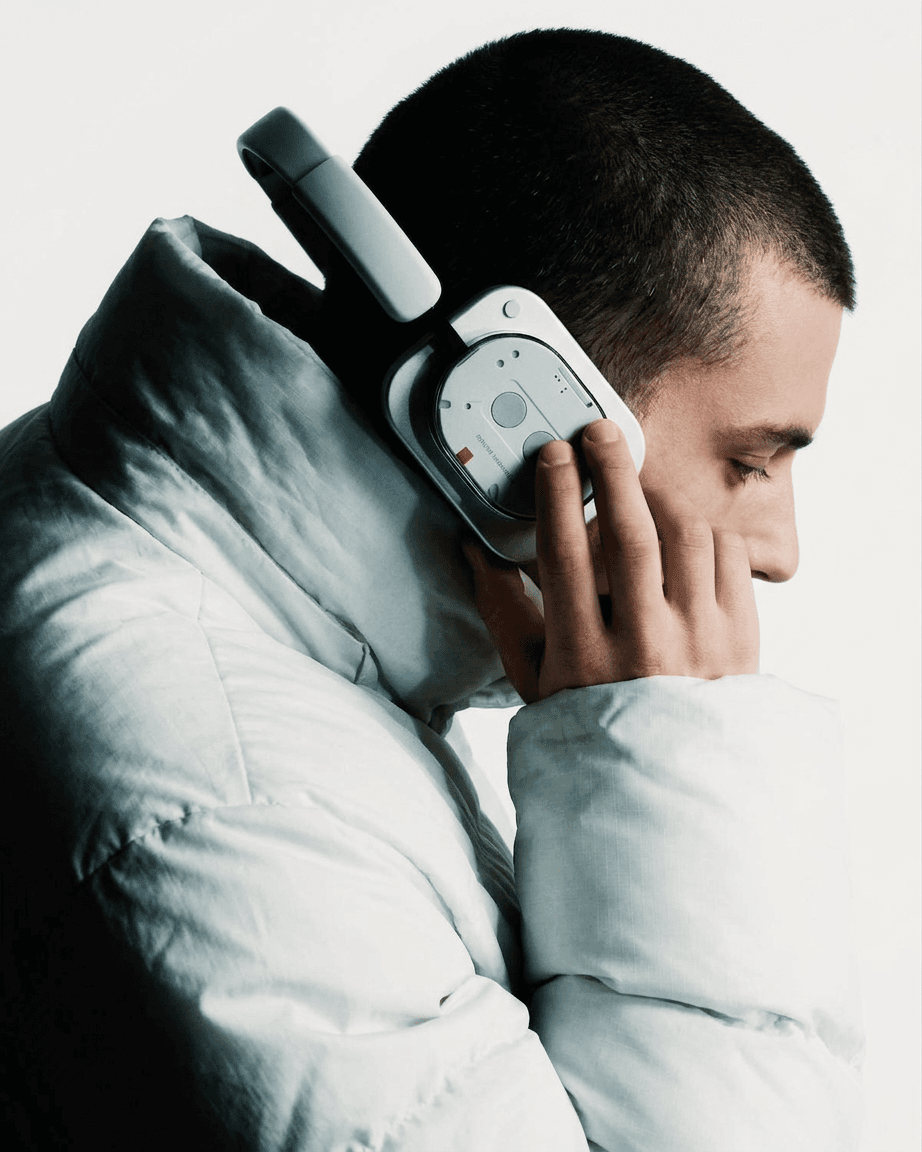 Profile of a man wearing a white puffer jacket and headphones