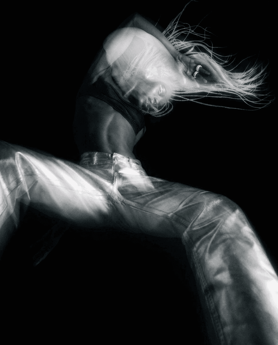 A woman in motion, showcasing dynamic movement with black and silver colours.