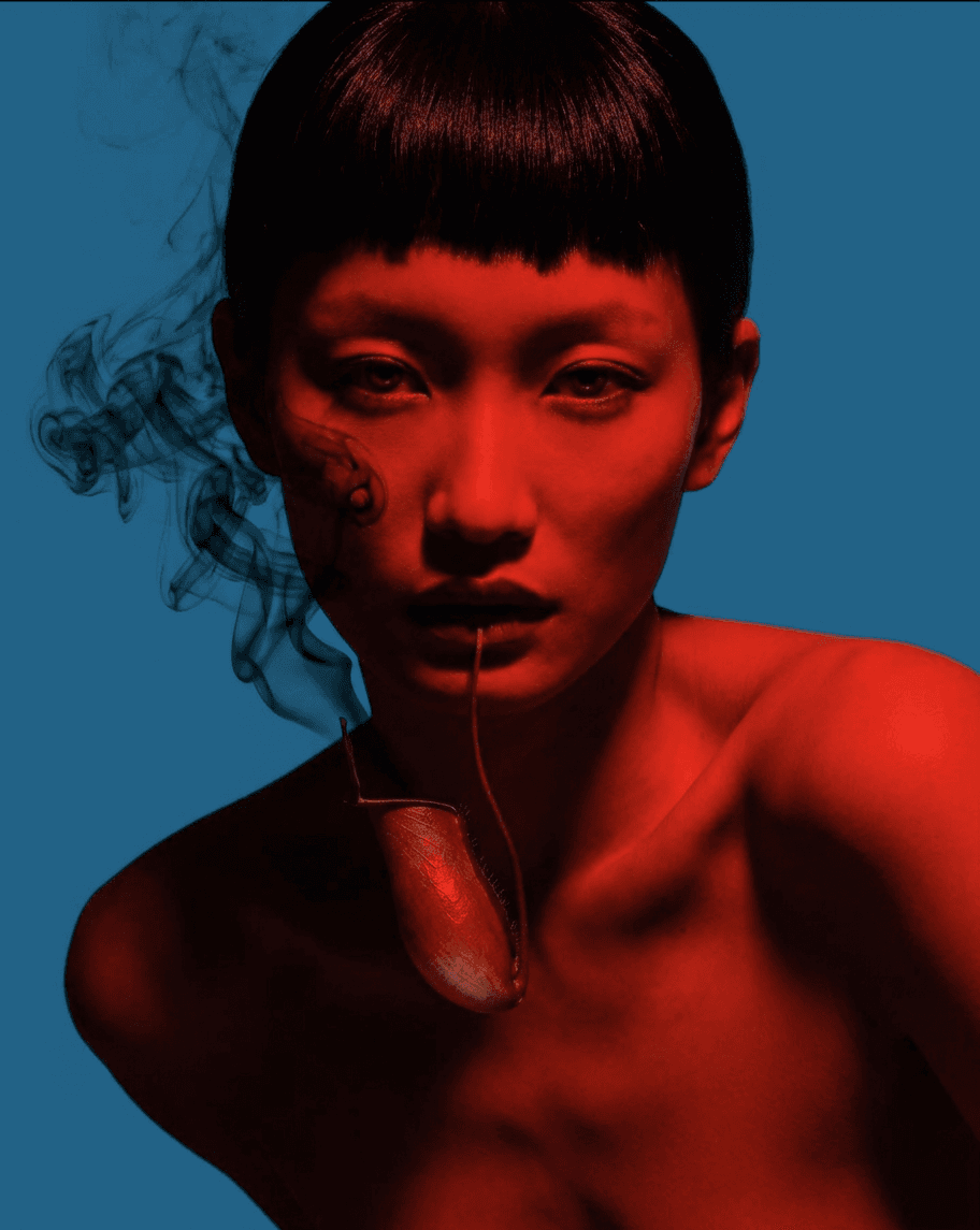 A woman with a striking expression, red tones and blue background.