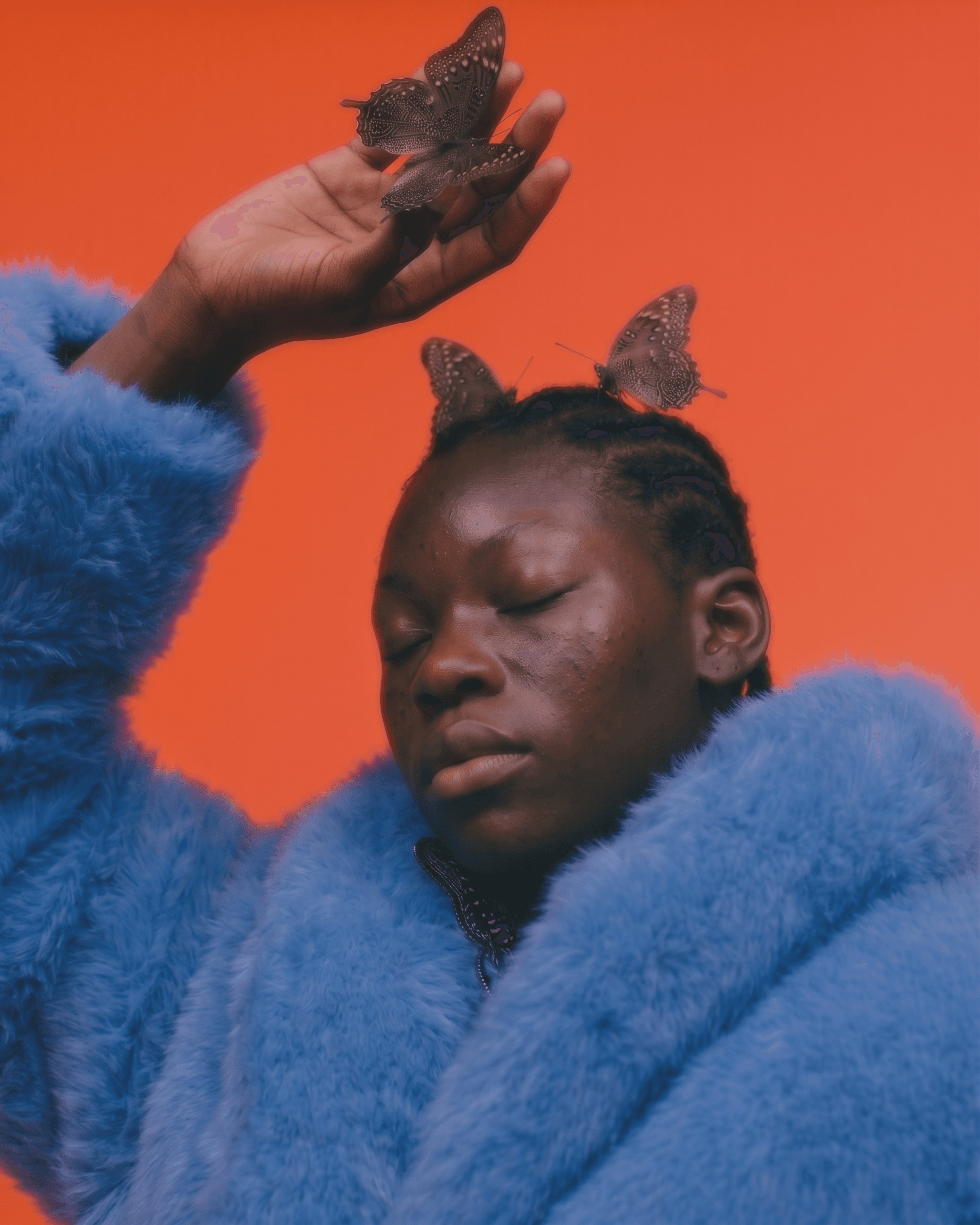 Portrait of a woman with closed eyes, butterflies on her head, and a blue fur coat against an orange backdrop.