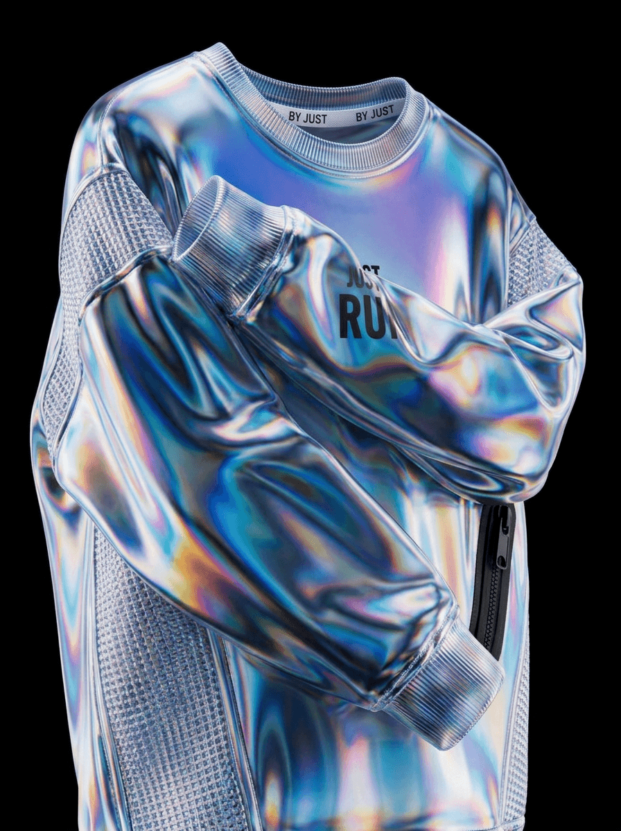 Close-up of a reflective, iridescent garment with vibrant colours on a black background.