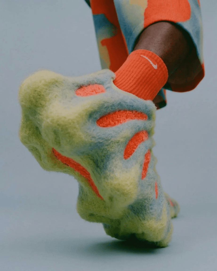 Full-figure shot of a creative footwear design on a textured background.