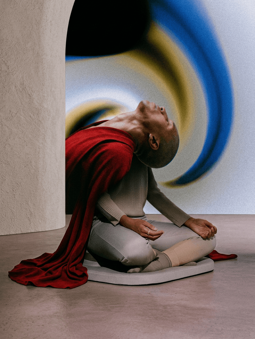 A man with a serene expression in a red cloak, surrounded by abstract swirling colours.