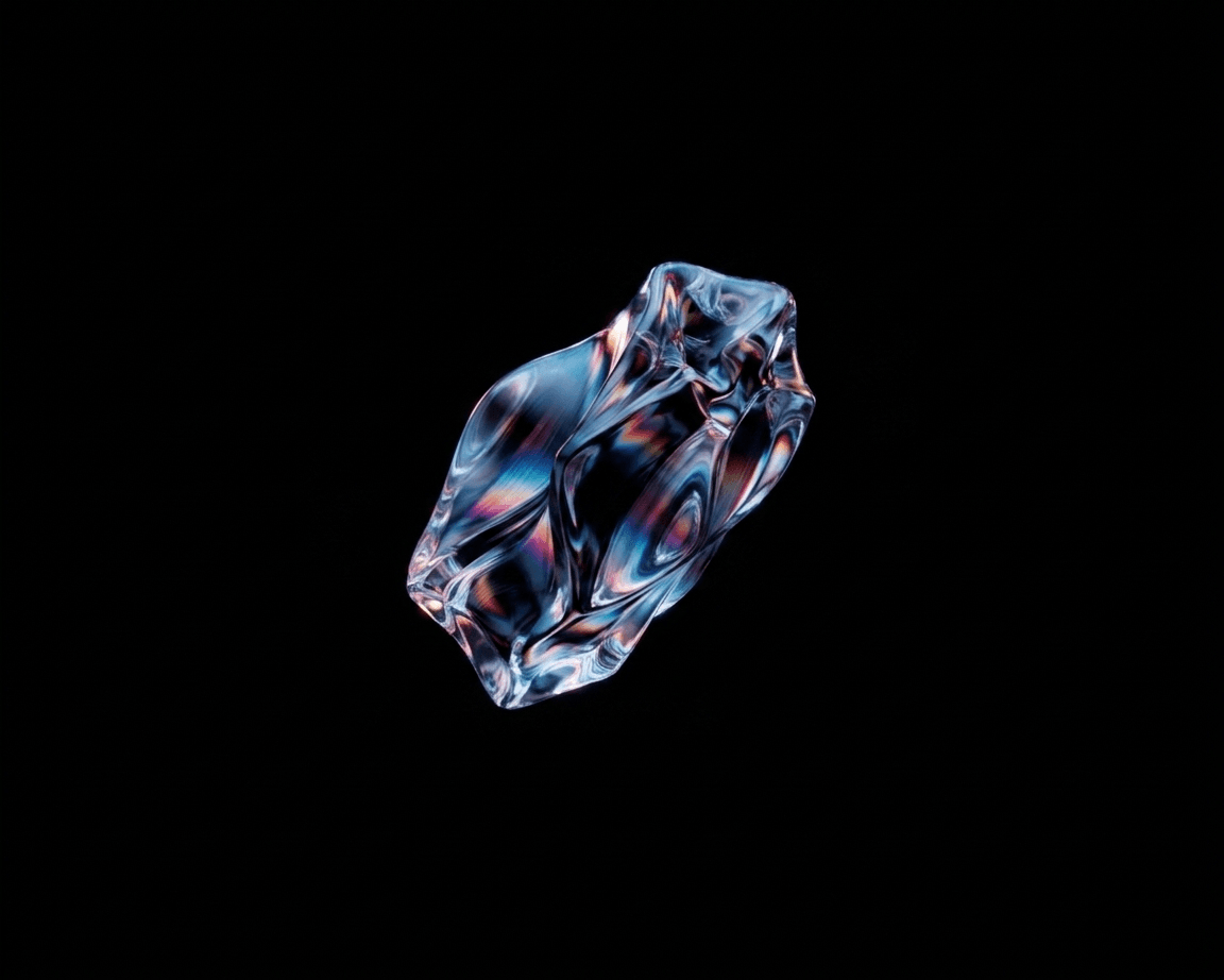 Translucent object with swirls of colour on a dark background.