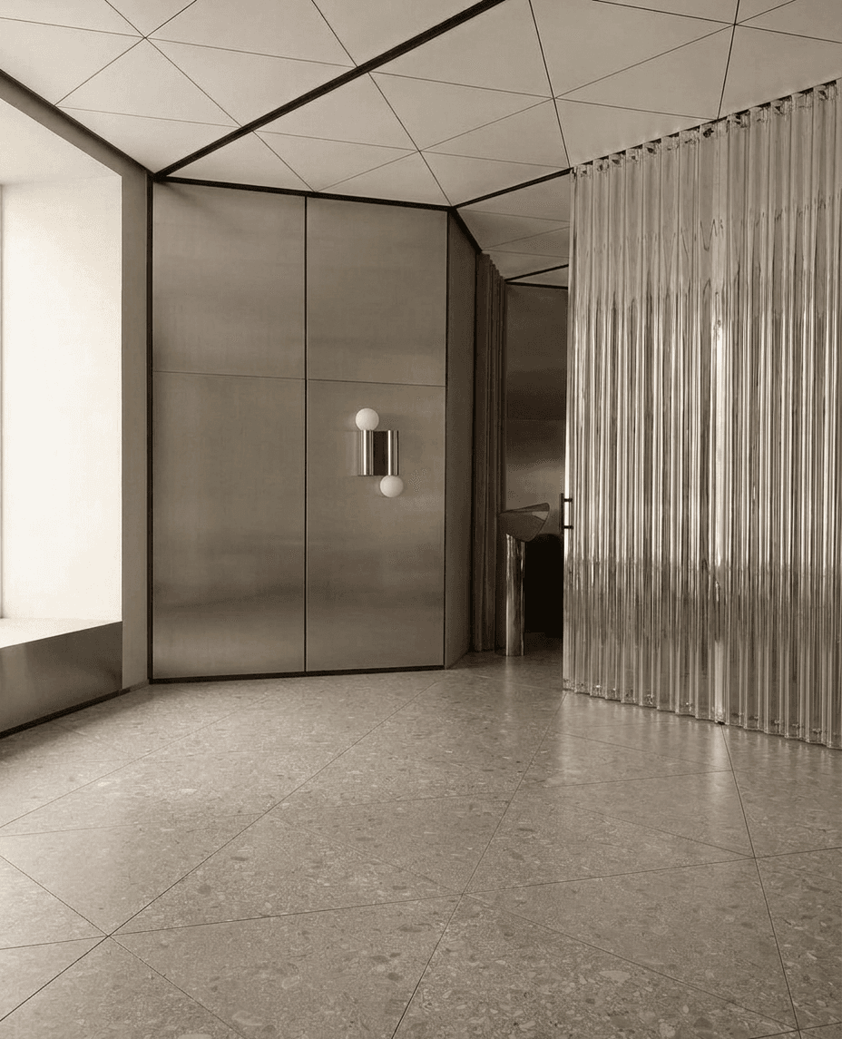 A modern interior with metallic surfaces, geometric designs, and neutral colours.