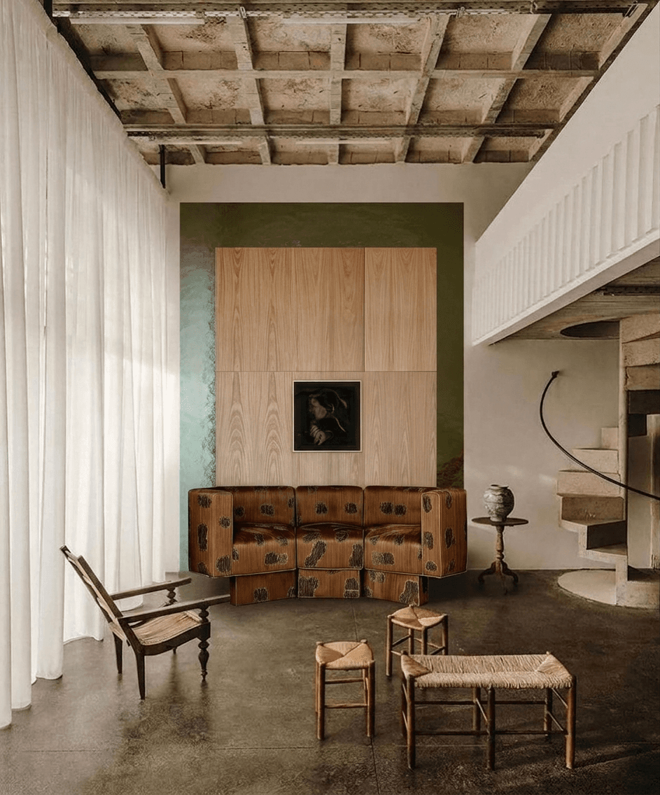 Interior scene of a modern living space with minimalist furniture and earthy colours.