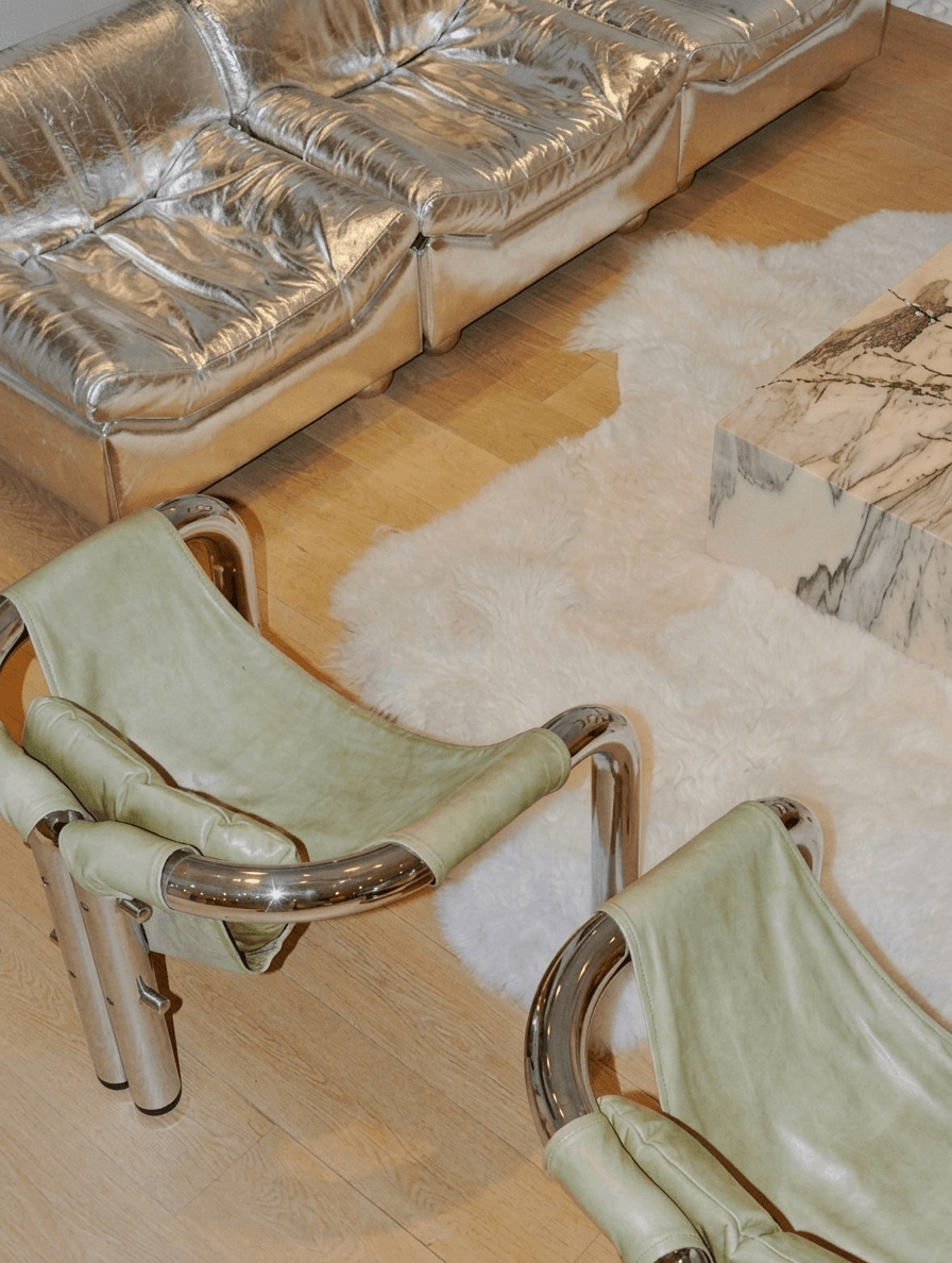 Interior with metallic furniture and a plush fur rug in silver and green.