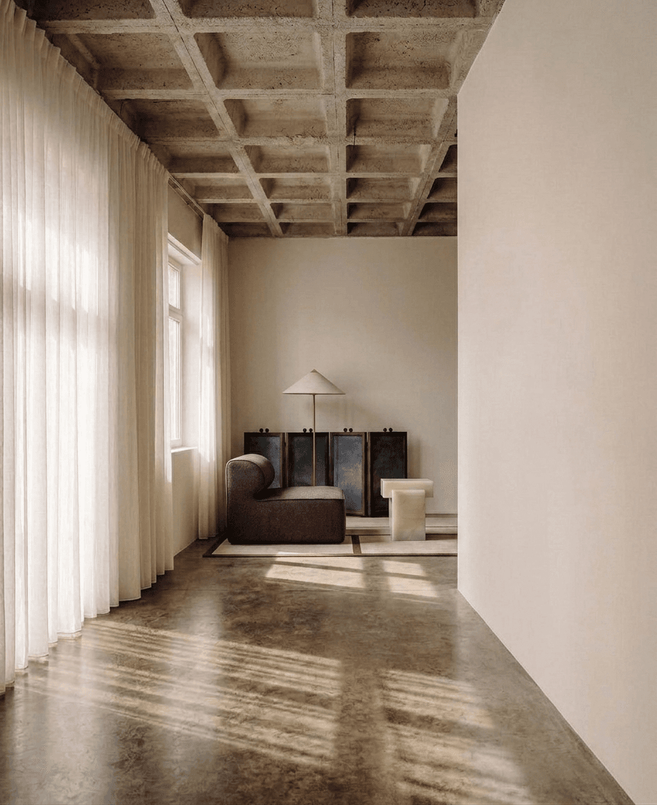 Interior scene with a sofa and unique furniture in soft, warm tones and natural light.