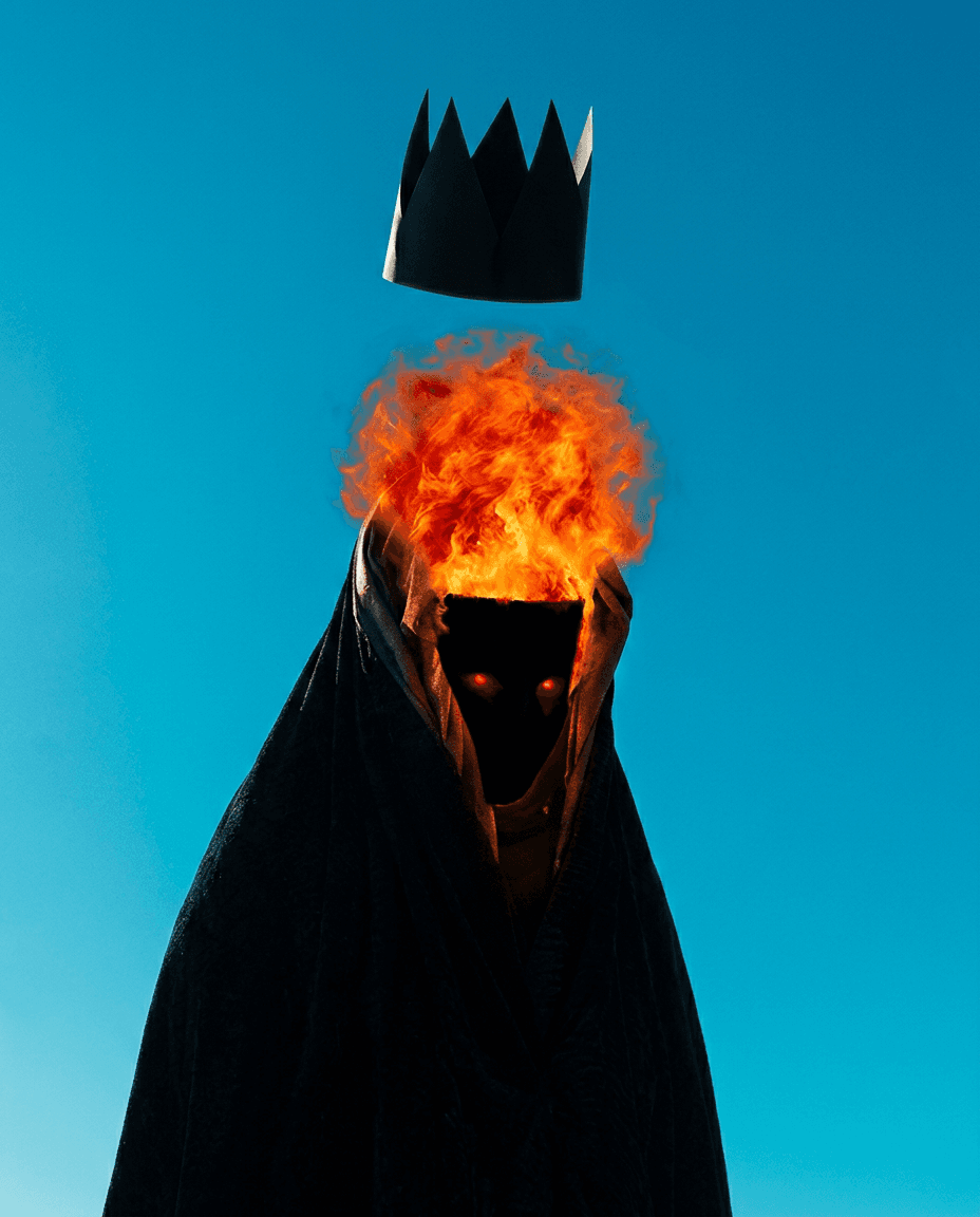 Cloaked figure with a crown floating in orange flames against a blue sky.