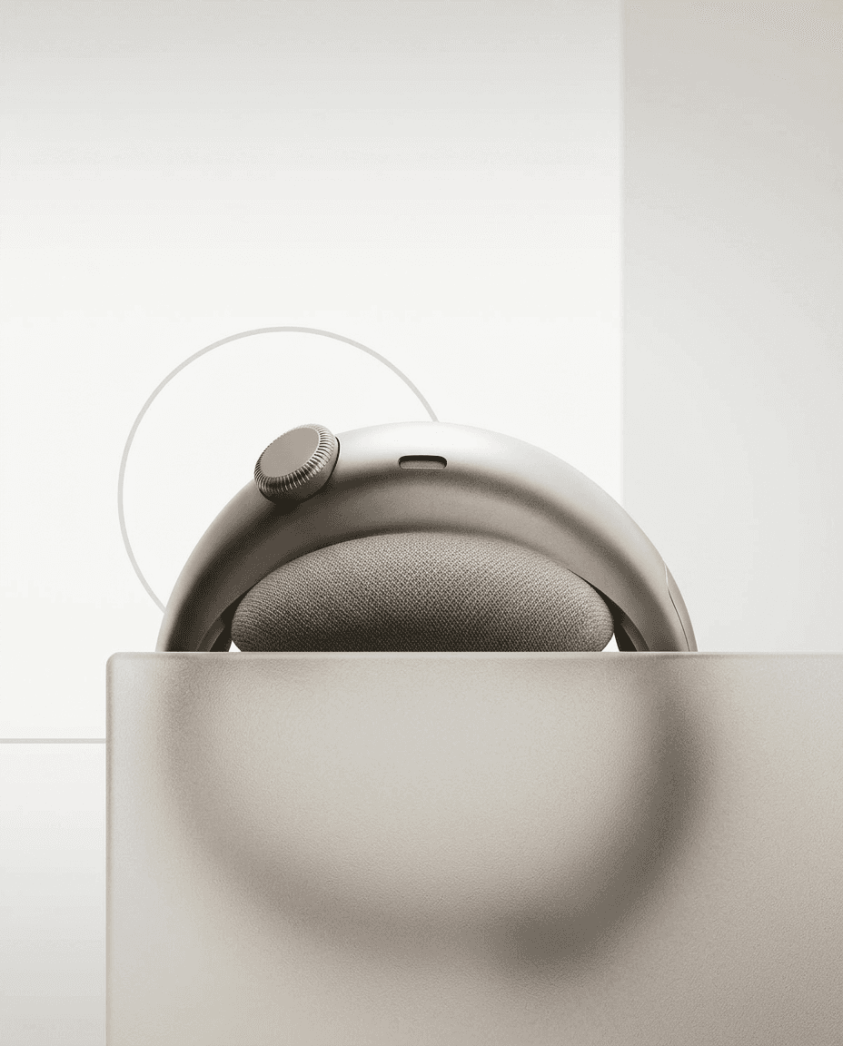 A pair of sleek headphones in silver and beige on a light background.