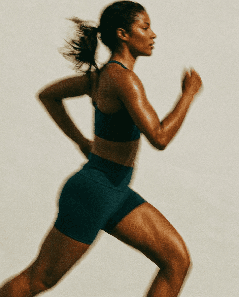 A muscular woman sprinting, showcasing athleticism in warm, muted colours.