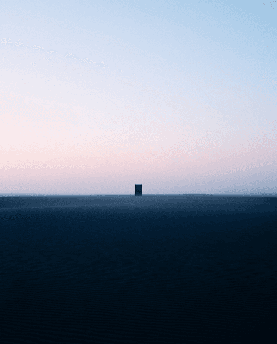 A solitary black structure against a soft gradient sky at dawn.