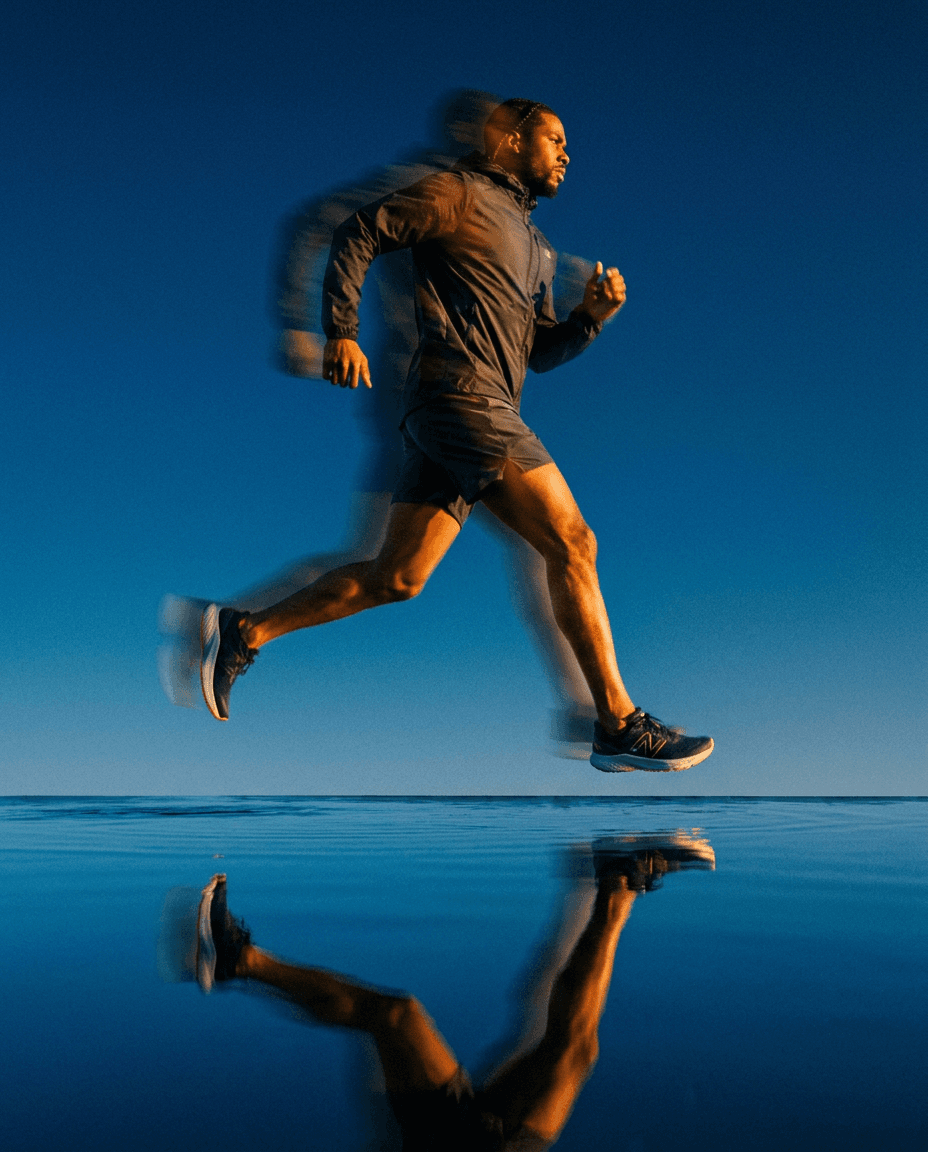 Runner in motion with a blue sky background and reflections in water.