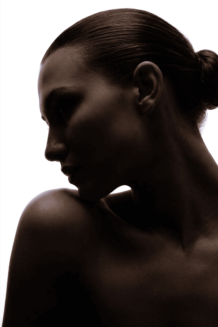 Silhouette of a woman against a bright white background.