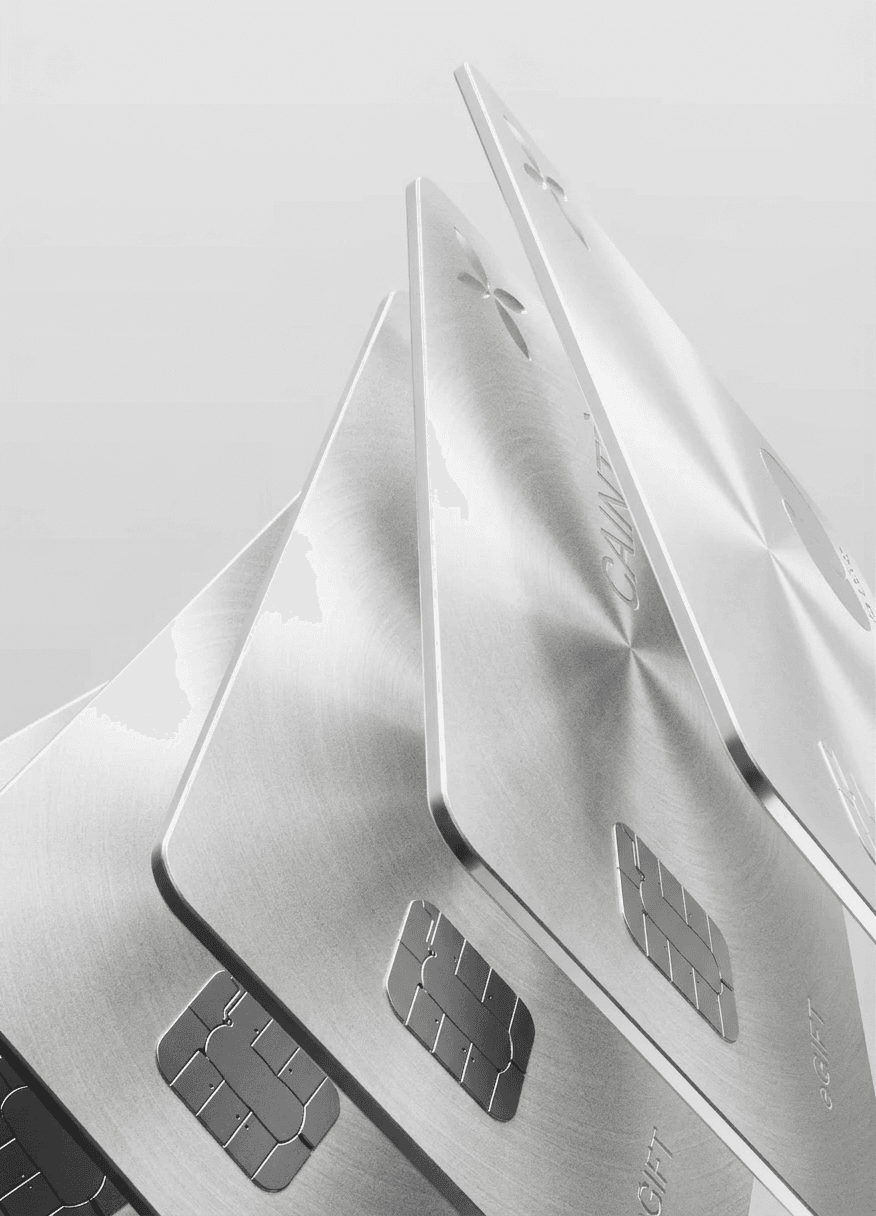 Close-up of metallic credit cards on a light grey background.