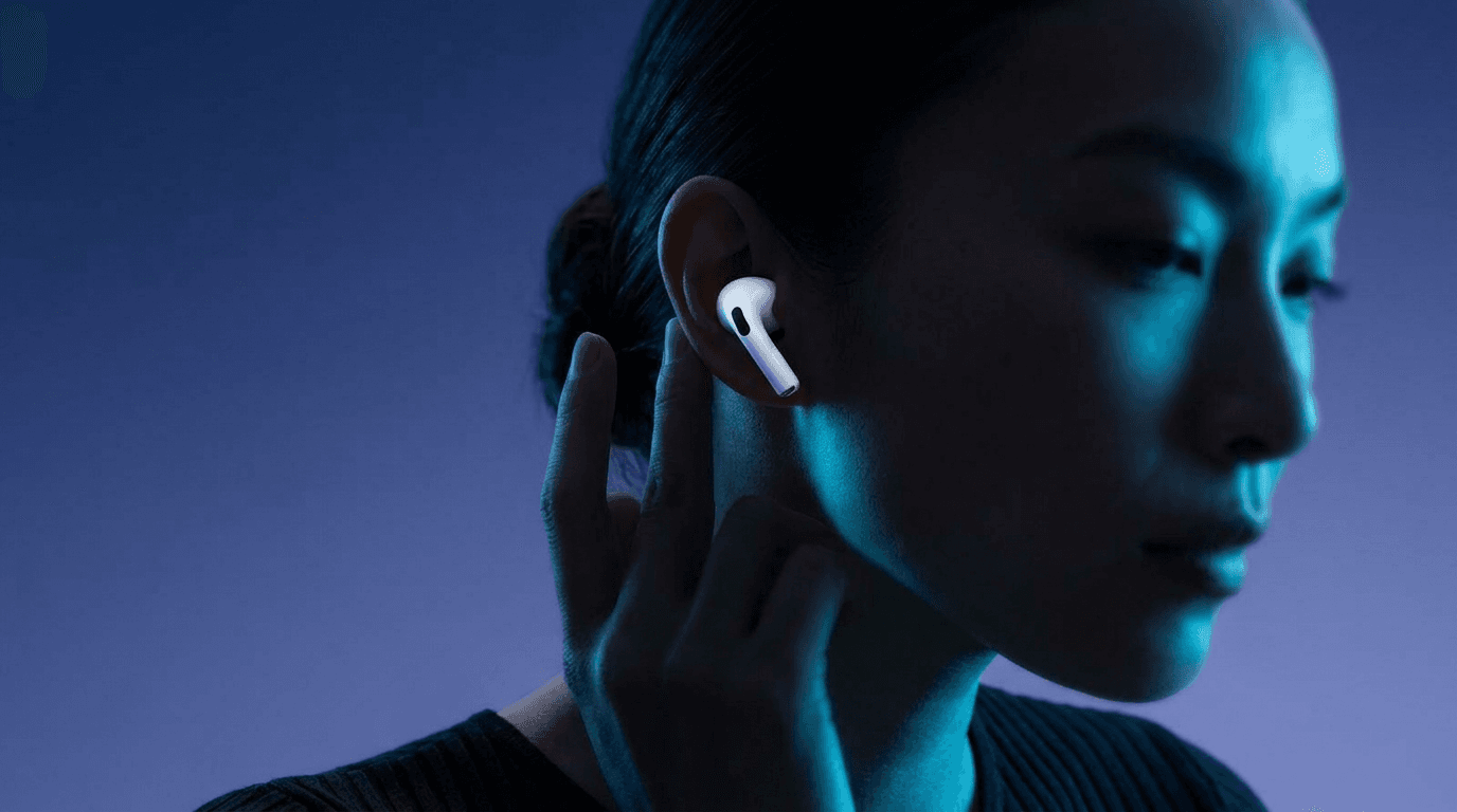 Close-up of a woman with AirPods on a blue and purple gradient background.
