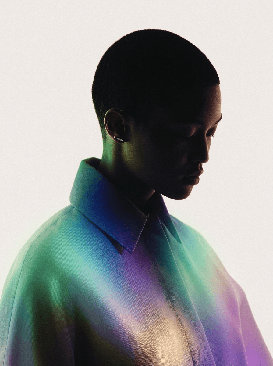 Silhouette of a figure in an iridescent shirt on a white background.