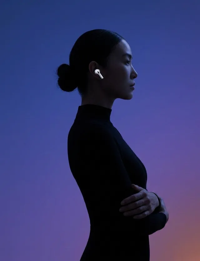 Profile silhouette of a woman in black with wireless earbuds against a gradient background.
