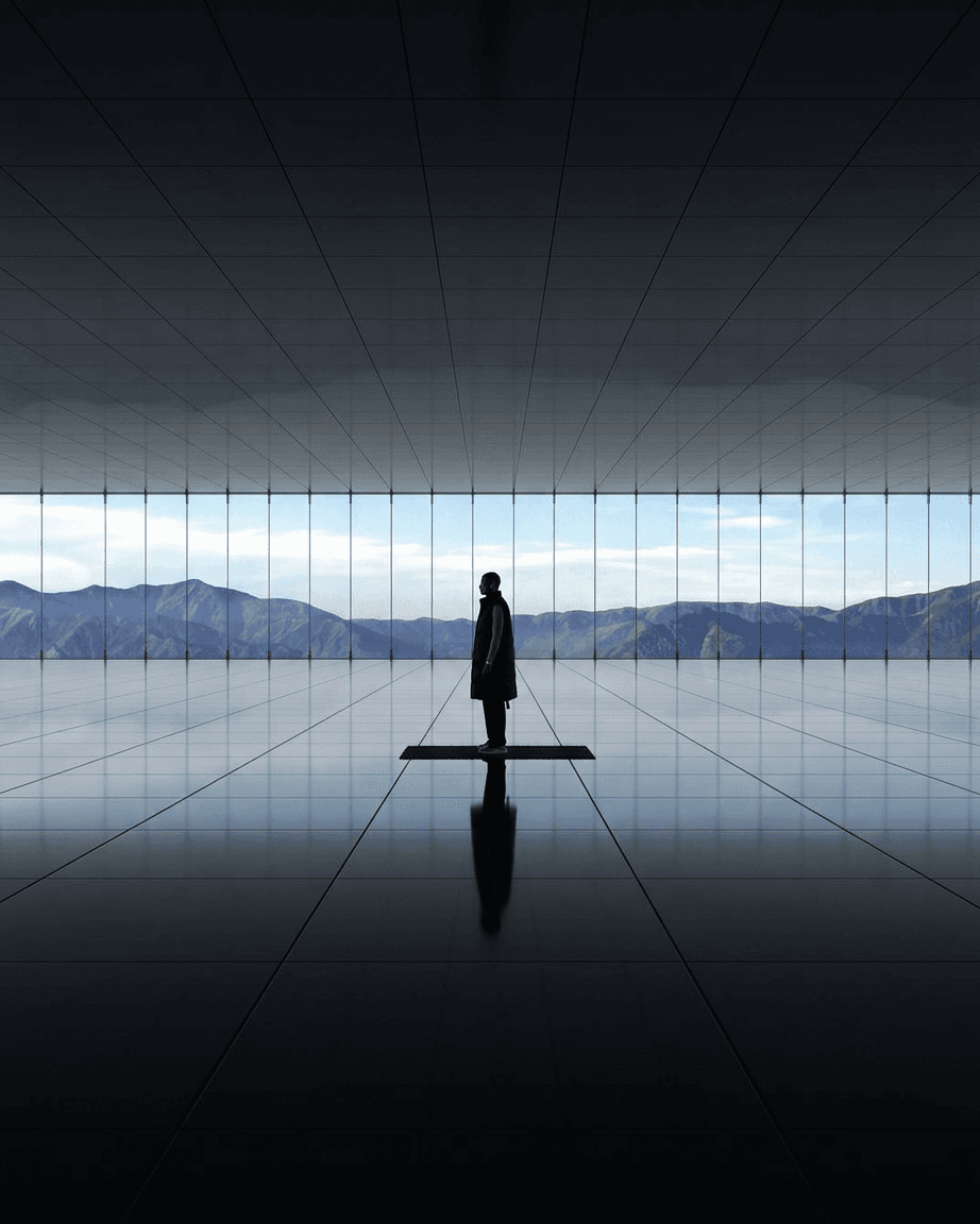 A figure on a mat in a minimalist room with glass walls and mountain reflections.