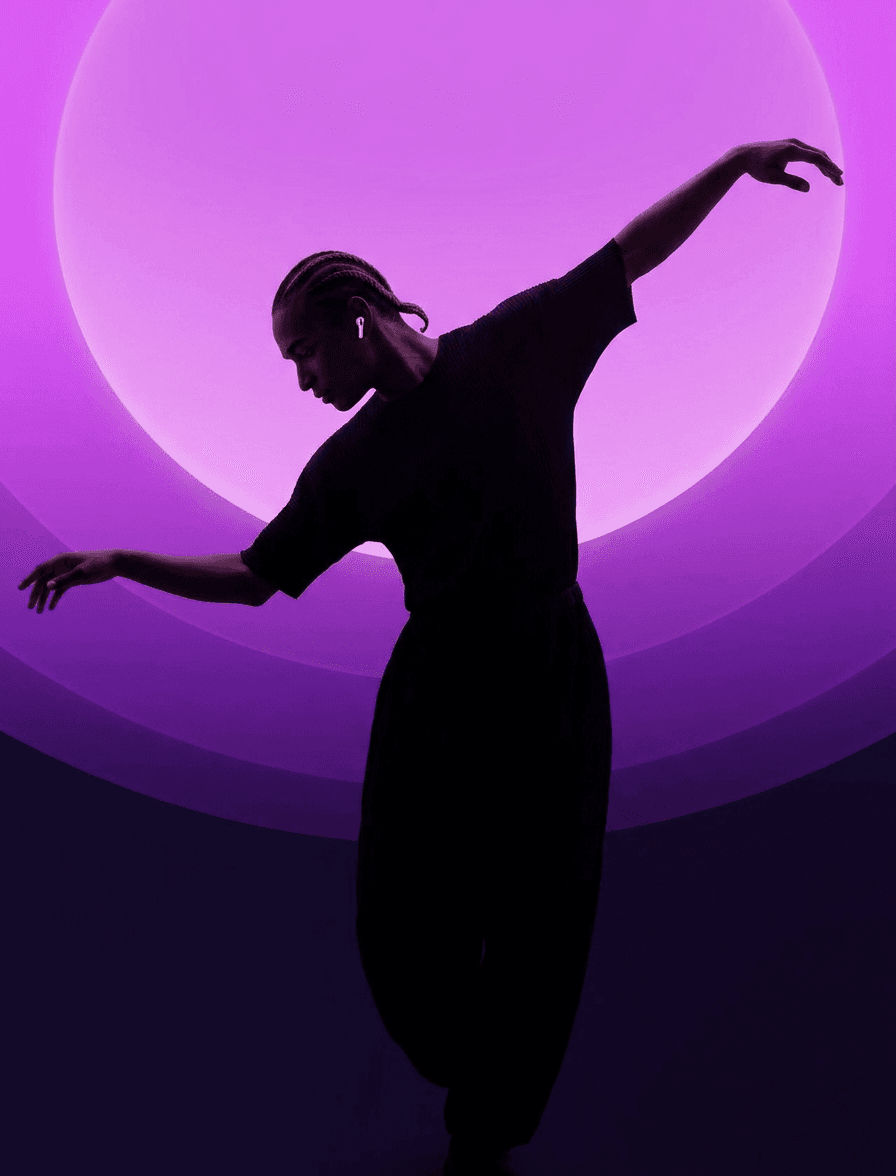 A dancer poses against a backdrop of purple gradients, creating a striking silhouette.
