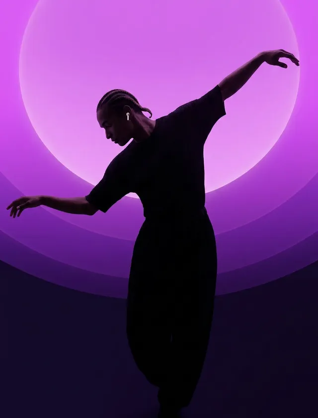 A dancer poses against a backdrop of purple gradients, creating a striking silhouette.