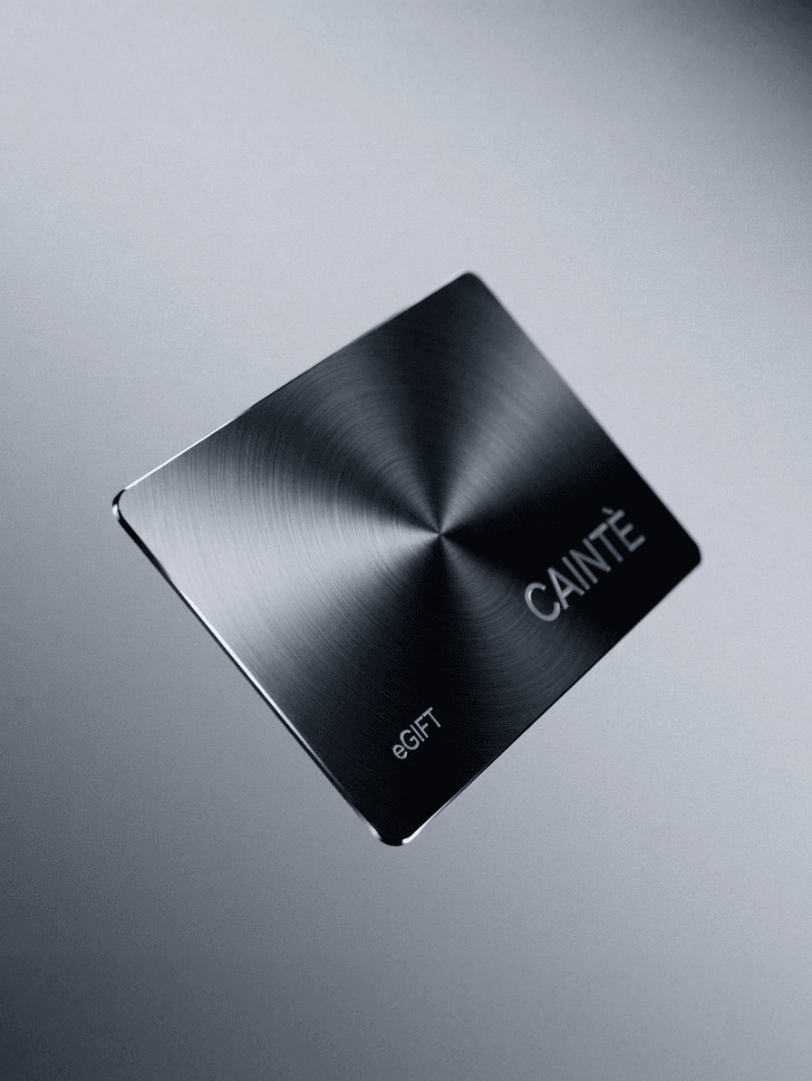 A metallic eGift card hovering on a grey gradient background.