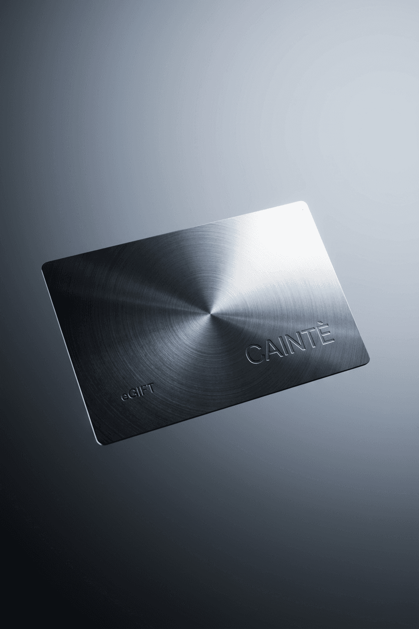 A metallic gift card with the word 'CAINTE' embossed on it.