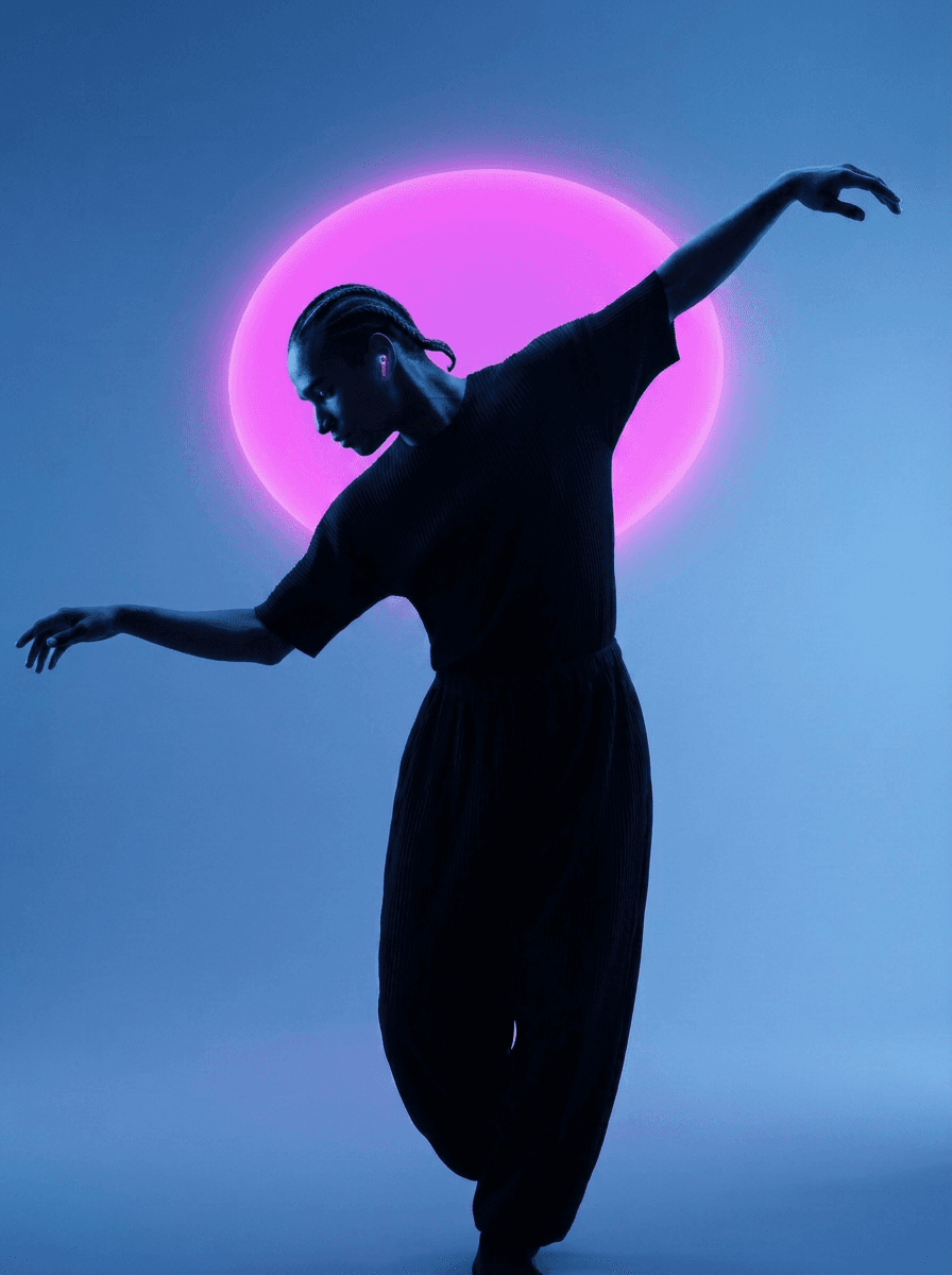 A dancer posed gracefully in front of a pink circular backdrop.